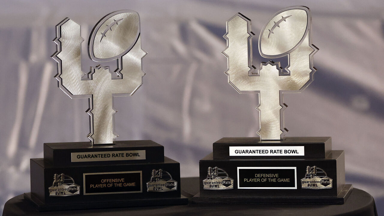 PHOENIX, ARIZONA - DECEMBER 27: A detail view of the offensive and defensive MVP trophies during the Guaranteed Rate Bowl between the Wisconsin Badgers and the Oklahoma State Cowboys at Chase Field on December 27, 2022 in Phoenix, Arizona. The Badgers beat the Cowboys 24-17.