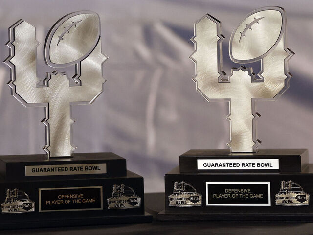 PHOENIX, ARIZONA - DECEMBER 27: A detail view of the offensive and defensive MVP trophies during the Guaranteed Rate Bowl between the Wisconsin Badgers and the Oklahoma State Cowboys at Chase Field on December 27, 2022 in Phoenix, Arizona. The Badgers beat the Cowboys 24-17.