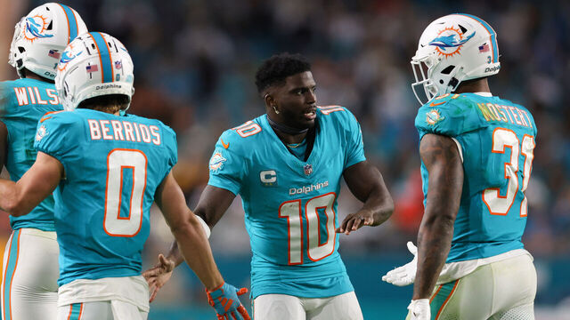 MIAMI GARDENS, FLORIDA - DECEMBER 11: Tyreek Hill #10 of the Miami Dolphins high fives teammates during the second quarter of the game against the Tennessee Titans at Hard Rock Stadium on December 11, 2023 in Miami Gardens, Florida.