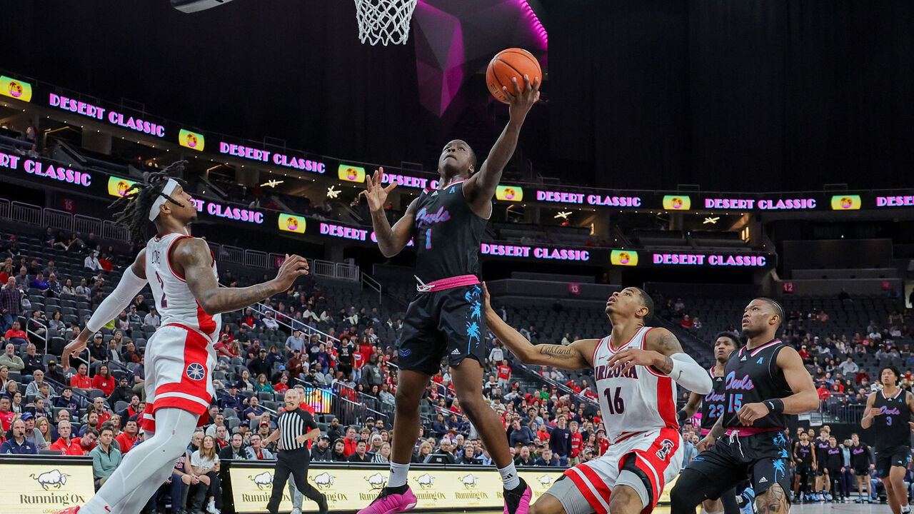 LAS VEGAS, NEVADA - DECEMBER 23: Johnell Davis #1 of the Florida Atlantic Owls shoots against Caleb Love #2 and Keshad Johnson #16 of the Arizona Wildcats in the first half of the Desert Classic at T-Mobile Arena on December 23, 2023 in Las Vegas, Nevada.