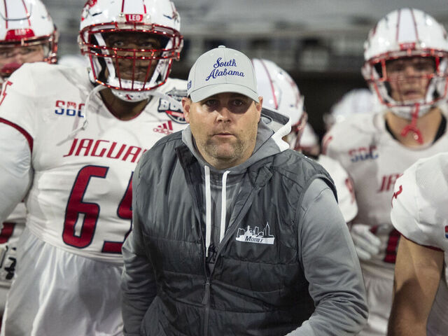 MOBILE, ALABAMA - DECEMBER 23: Head coach Kane Wommack of the South Alabama Jaguars leads his team on to the field prior to their game against the Eastern Michigan Eagles in the 68 Ventures Bowl at Hancock Whitney Stadium on December 23, 2023 in Mobile, Alabama.