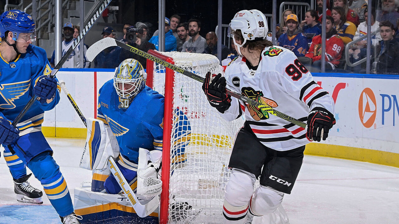 ST. LOUIS, MO - DECEMBER 23: Connor Bedard #98 of the Chicago Blackhawks scores a goal against Jordan Binnington #50 of the St. Louis Blues on December 23, 2023 at the Enterprise Center in St. Louis, Missouri.