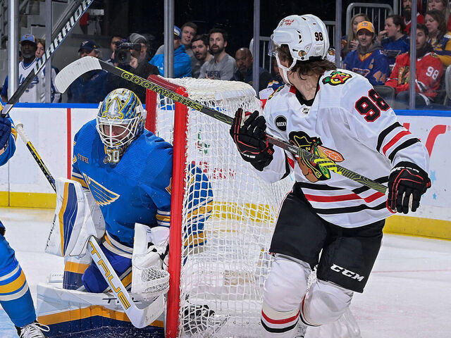 ST. LOUIS, MO - DECEMBER 23: Connor Bedard #98 of the Chicago Blackhawks scores a goal against Jordan Binnington #50 of the St. Louis Blues on December 23, 2023 at the Enterprise Center in St. Louis, Missouri.