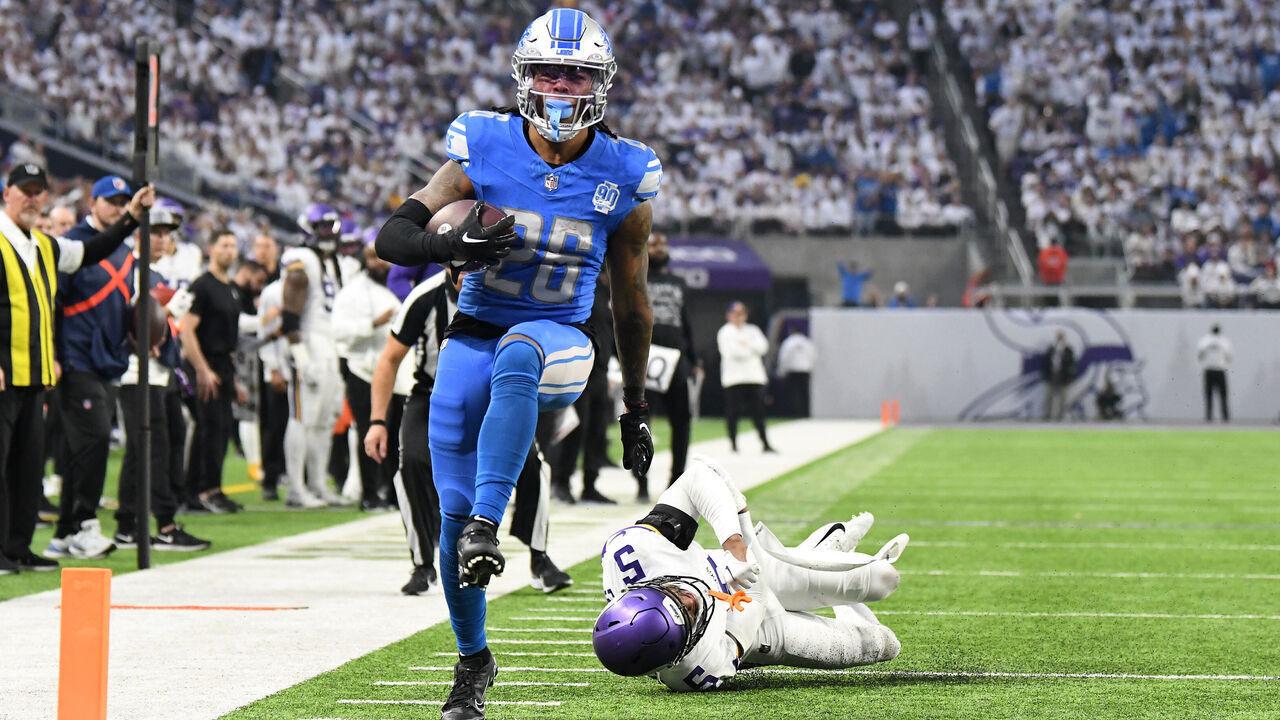 MINNEAPOLIS, MINNESOTA - DECEMBER 24: Jahmyr Gibbs #26 of the Detroit Lions scores a rushing touchdown against Mekhi Blackmon #5 of the Minnesota Vikings during the second quarter at U.S. Bank Stadium on December 24, 2023 in Minneapolis, Minnesota.