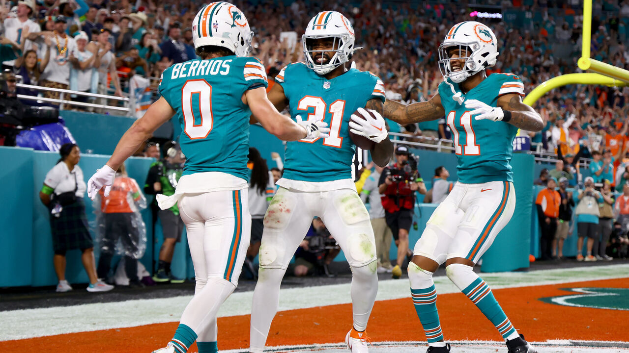 MIAMI GARDENS, FLORIDA - DECEMBER 24: Raheem Mostert #31 of the Miami Dolphins celebrates after a touchdown with Braxton Berrios #0 and Cedrick Wilson Jr. #11 during the second quarter in the game against the Dallas Cowboys at Hard Rock Stadium on December 24, 2023 in Miami Gardens, Florida.