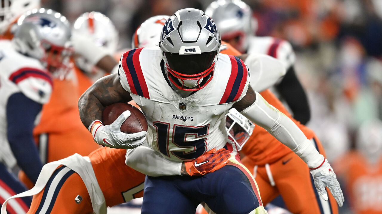 DENVER, COLORADO - DECEMBER 24: Running back Ezekiel Elliott #15 of the New England Patriots carries the ball during the 1st quarter of the game against the Denver Broncos at Empower Field At Mile High on December 24, 2023 in Denver, Colorado.