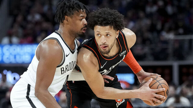 DETROIT, MICHIGAN - DECEMBER 26: Cade Cunningham #2 of the Detroit Pistons handles the ball against Dennis Smith Jr. #4 of the Brooklyn Nets during the first quarter at Little Caesars Arena on December 26, 2023 in Detroit, Michigan.