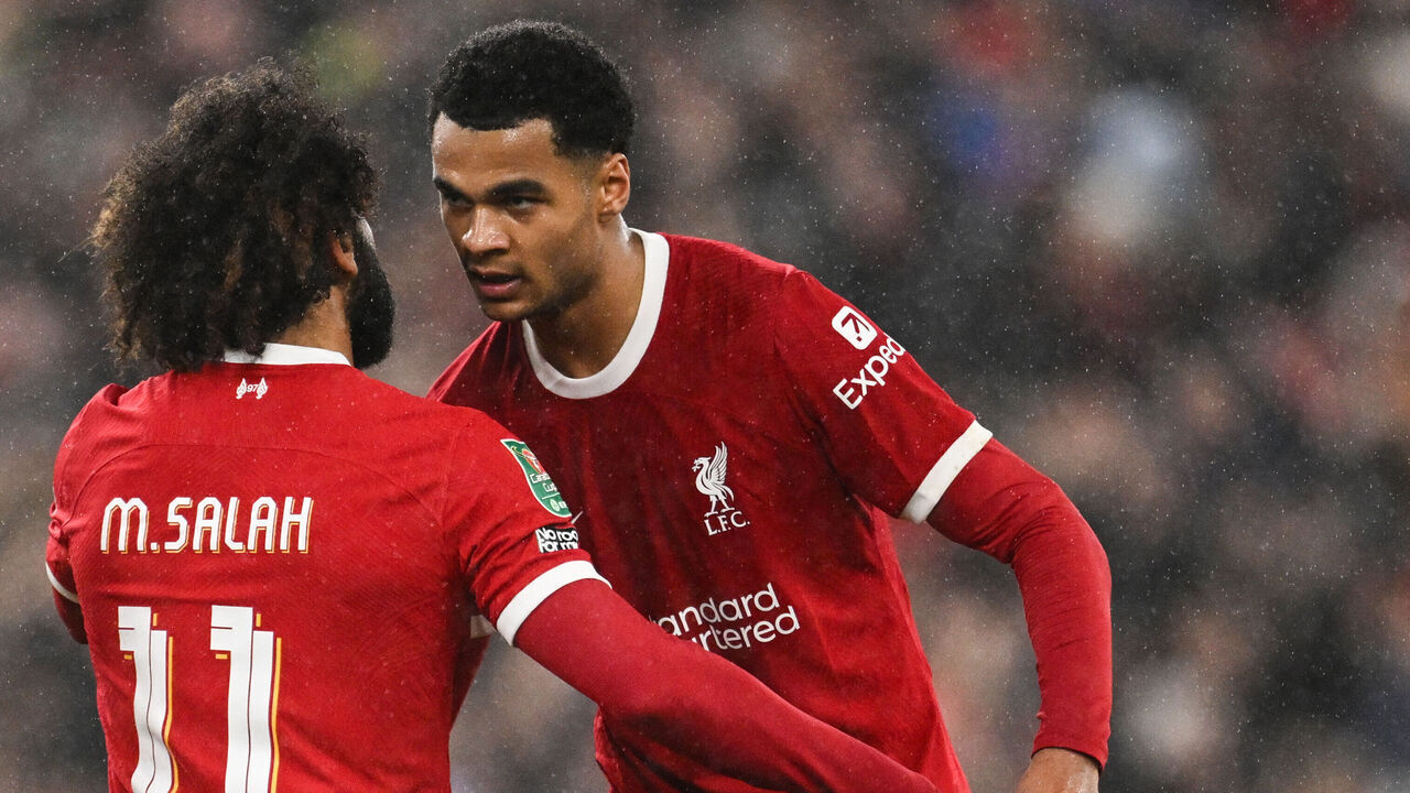 Liverpool's Dutch striker #18 Cody Gakpo (R) celebrates with Liverpool's Egyptian striker #11 Mohamed Salah after scoring his team third goal during the English League Cup quarter-final football match between Liverpool and West Ham United at Anfield in Liverpool, north west England on December 20, 2023.