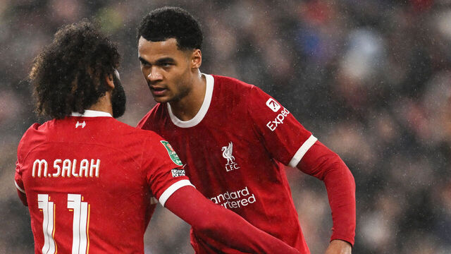 Liverpool's Dutch striker #18 Cody Gakpo (R) celebrates with Liverpool's Egyptian striker #11 Mohamed Salah after scoring his team third goal during the English League Cup quarter-final football match between Liverpool and West Ham United at Anfield in Liverpool, north west England on December 20, 2023.