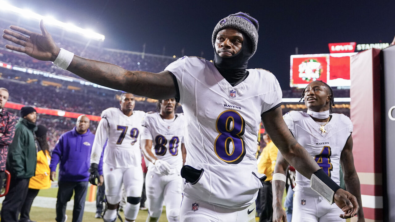 SANTA CLARA, CALIFORNIA - DECEMBER 25: Lamar Jackson #8 of the Baltimore Ravens high fives a fan while heading into the locker room after the first half against the San Francisco 49ers at Levi's Stadium on December 25, 2023 in Santa Clara, California.