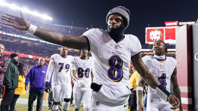SANTA CLARA, CALIFORNIA - DECEMBER 25: Lamar Jackson #8 of the Baltimore Ravens high fives a fan while heading into the locker room after the first half against the San Francisco 49ers at Levi's Stadium on December 25, 2023 in Santa Clara, California.