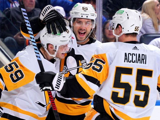 ELMONT, NEW YORK - DECEMBER 27: Jake Guentzel #59 of the Pittsburgh Penguins is congratulated by Kris Letang #58 and Noel Acciari #55 after scoring a goal against the New York Islanders during the second period at UBS Arena on December 27, 2023 in Elmont, New York.