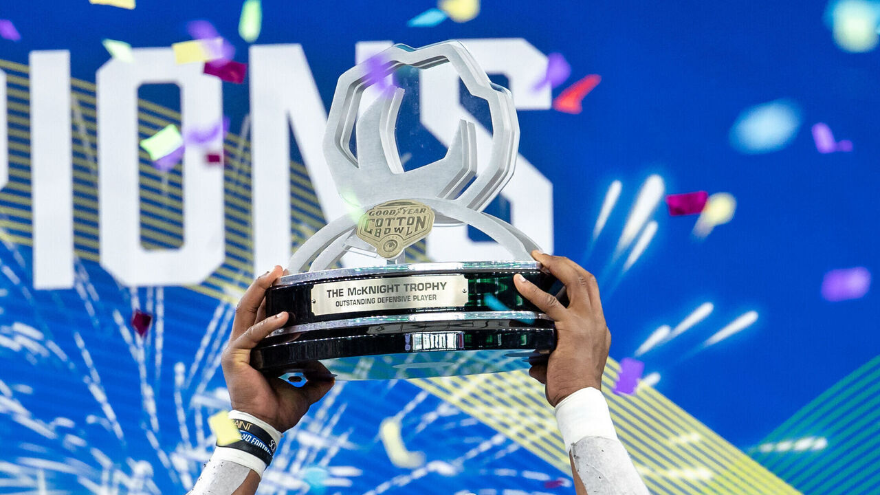 ARLINGTON, TX - JANUARY 02: Tulane Green Wave linebacker Dorian Williams (#2) is awarded the defensive MVP trophy during the Goodyear Cotton Bowl game between the USC Trojans and Tulane Green Wave on January 02, 2023 at AT&T Stadium in Arlington, TX.
