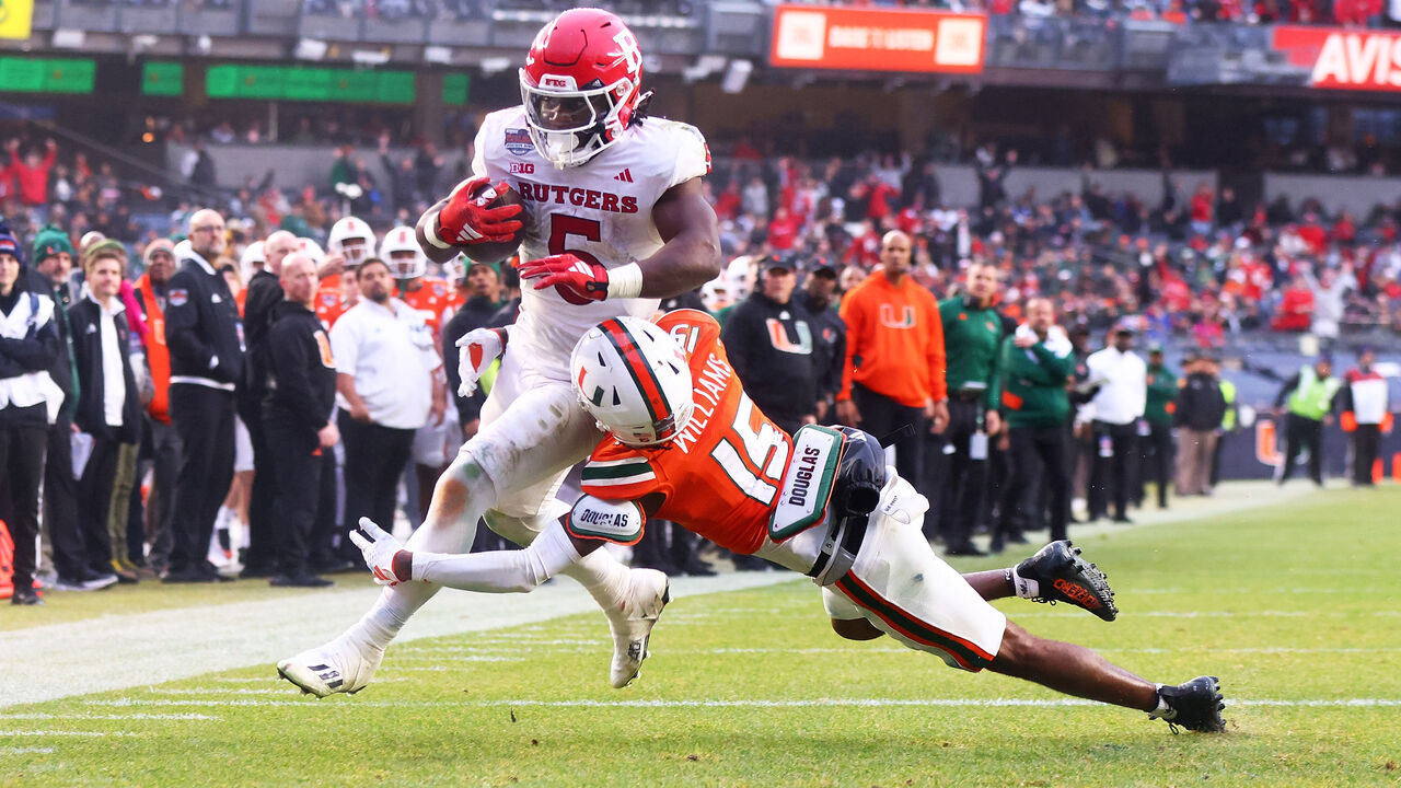 NEW YORK, NEW YORK - DECEMBER 28: Kyle Monangai #5 of the Rutgers Scarlet Knights rushes for a second quarter touchdown against Markeith Williams #15 of the Miami Hurricanes during the Bad Boy Mowers Pinstripe Bowl at Yankee Stadium on December 28, 2023 in New York City.
