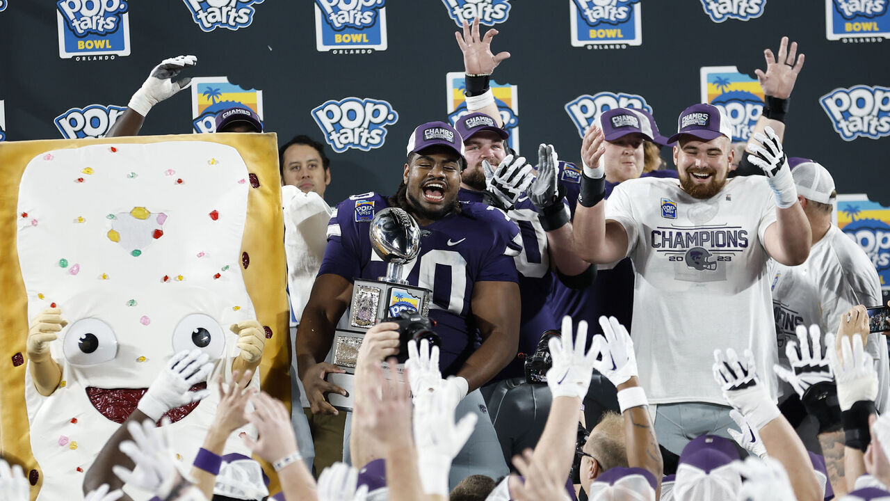 ORLANDO, FL - DECEMBER 28: Kansas State Wildcats offensive lineman KT Leveston (70) hold the trophy awarded to the winning team, after the game between the North Carolina State Wolfpack and the Kansas State Wildcats on December 28, 2023 at Camping World Stadium in Orlando, Fl.