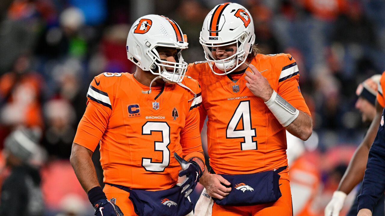 DENVER, COLORADO - DECEMBER 24: Russell Wilson #3 and Jarrett Stidham #4 of the Denver Broncos warm up before a game against the New England Patriots at Empower Field at Mile High on December 24, 2023 in Denver, Colorado.
