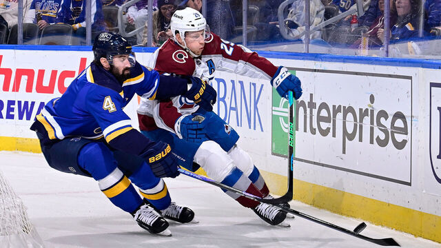 ST. LOUIS, MO - DECEMBER 29: Nick Leddy #4 of the St. Louis Blues defends against Nathan MacKinnon #29 of the Colorado Avalanche on December 29, 2023 at the Enterprise Center in St. Louis, Missouri.