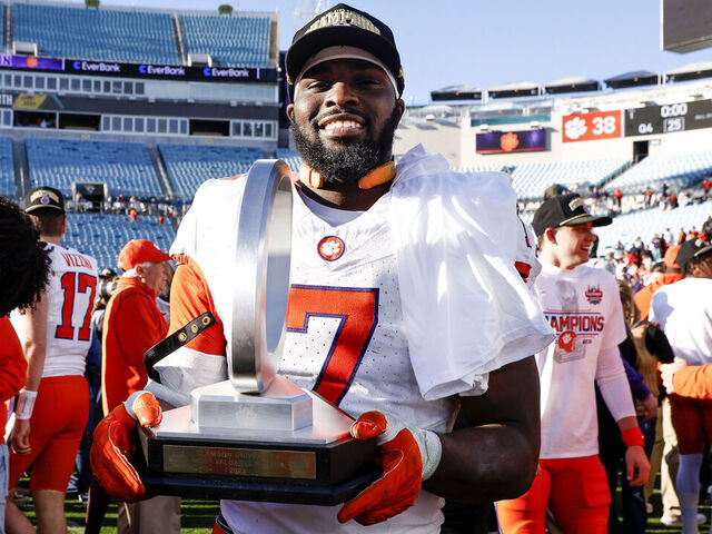 JACKSONVILLE, FL - DECEMBER 29: Running back Phil Mafah #7 of the Clemson Tigers poses with his MVP trophy after the game against the Kentucky Wildcats at the 79th annual TaxSlayer Gator Bowl at EverBank Stadium on December 29, 2023 in Jacksonville, Florida. The Tigers defeated the Wildcats 38 to 35.