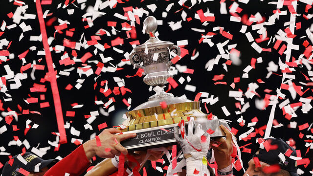 NEW ORLEANS, LOUISIANA - JANUARY 01: Head coach Ryan Day, Justin Fields #1 and Tuf Borland #32 of the Ohio State Buckeyes lift the trophy after defeating the Clemson Tigers 49-28 during the College Football Playoff semifinal game at the Allstate Sugar Bowl at Mercedes-Benz Superdome on January 01, 2021 in New Orleans, Louisiana.