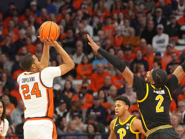 SYRACUSE, NY - DECEMBER 30: Syracuse Orange Guard Quadir Copeland (24) shoots a three point jump shot against Pittsburgh Panthers Forward Blake Hinson (2) during the first half of the College Basketball game between the Pittsburgh Panthers and the Syracuse Orange on December 30, 2023, at the JMA Wireless Dome in Syracuse, NY.