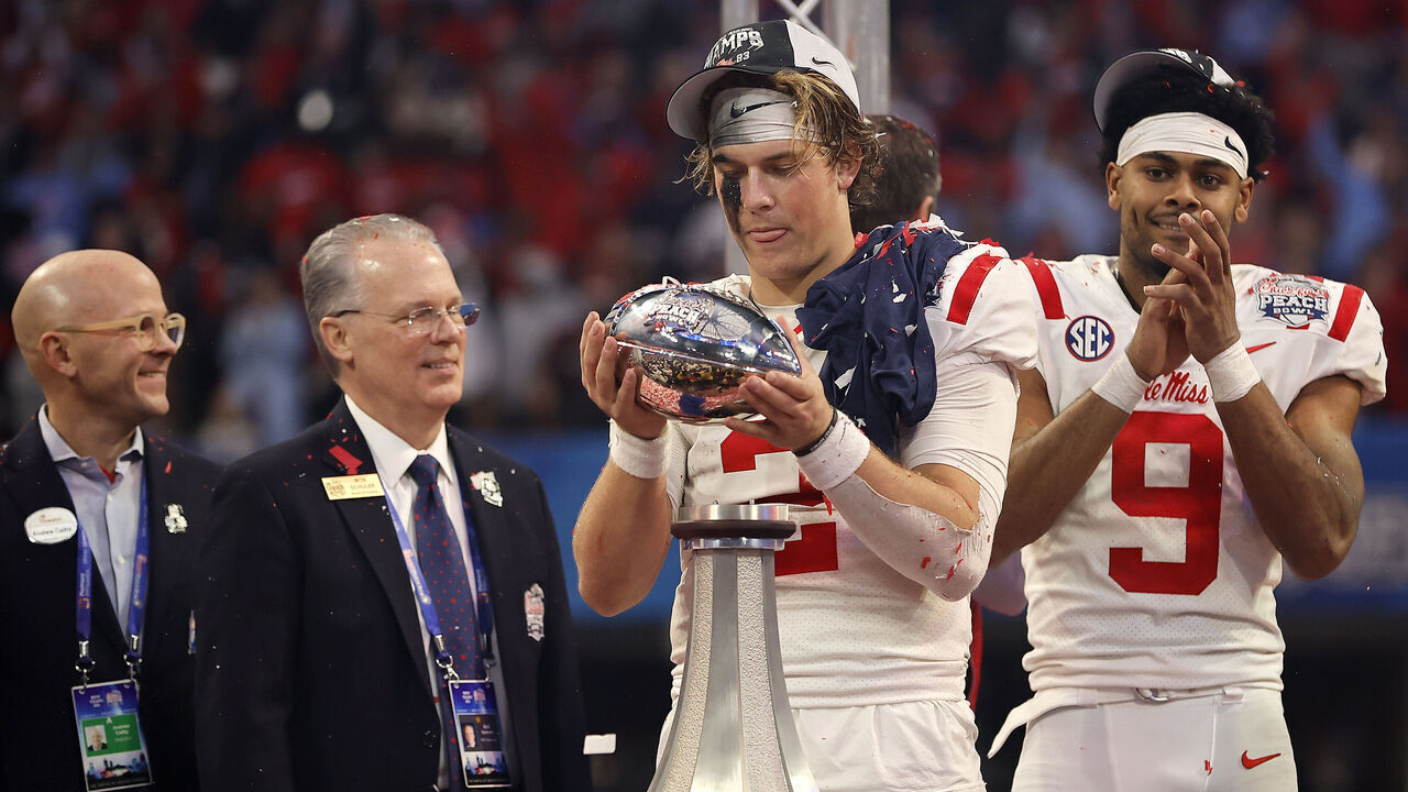 ATLANTA, GEORGIA - DECEMBER 30: The George P. Crumbley Trophy breaks as Jaxson Dart #2 and Tre Harris #9 of the Mississippi Rebels celebrate after beating Penn State Nittany Lions during the Chick-fil-A Peach Bowl at Mercedes-Benz Stadium on December 30, 2023 in Atlanta, Georgia.