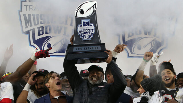 NASHVILLE, TN - DECEMBER 30: Maryland Terrapins head coach Mike Locksley hoists the trophy following the the TransPerfect Music City Bowl between the Auburn Tigers and Maryland Terrapins, December 30, 2023 at Nissan Stadium in Nashville, Tennessee.