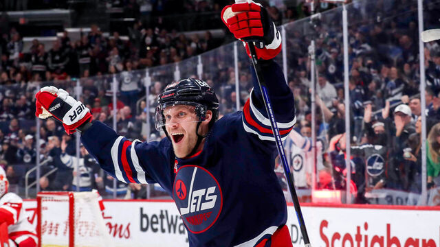 WINNIPEG, CANADA - MARCH 31: Nikolaj Ehlers #27 of the Winnipeg Jets celebrates after teammate Blake Wheeler #26 (not seen) scores a first period goal against the Detroit Red Wings at the Canada Life Centre on March 31, 2023 in Winnipeg, Manitoba, Canada.