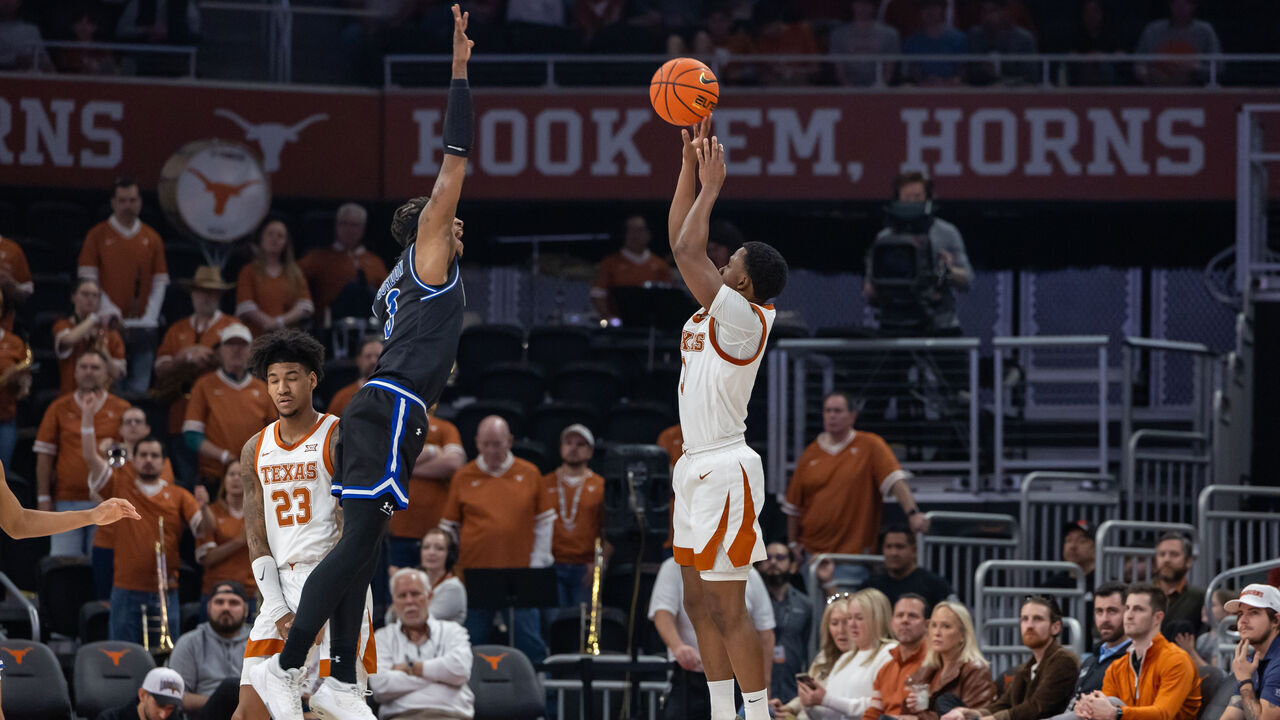 AUSTIN, TX - JANUARY 01: Texas Longhorns guard Max Abmas (3) takes a three point shot while Texas-Arlington Mavericks guard DaJuan Gordon (3) tries to block the shot during the college basketball game between Texas Longhorns and Texas-Arlington Mavericks on January 1, 2024, at Moody Center in Austin, Texas.