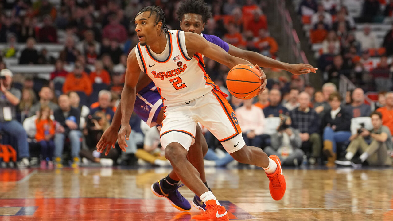 SYRACUSE, NY - DECEMBER 21: Syracuse Orange Guard JJ Starling (2) dribbles the ball past Niagara Purple Eagles Forward Yaw Obeng-Mensah (15) during the second half of the College Basketball game between the Niagara Purple Eagles and the Syracuse Orange on December 21, 2023, at the JMA Wireless Dome in Syracuse, NY.