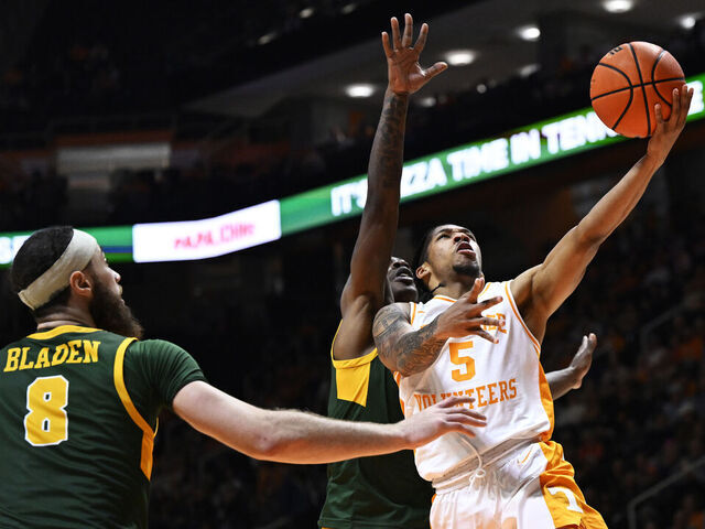 KNOXVILLE, TENNESSEE - JANUARY 02: Zakai Zeigler #5 of the Tennessee Volunteers goes for a layup against Tyrel Bladen #8 and Christian Ings #0 of the Norfolk State Spartans in the first half at Thompson-Boling Arena on January 02, 2024 in Knoxville, Tennessee.