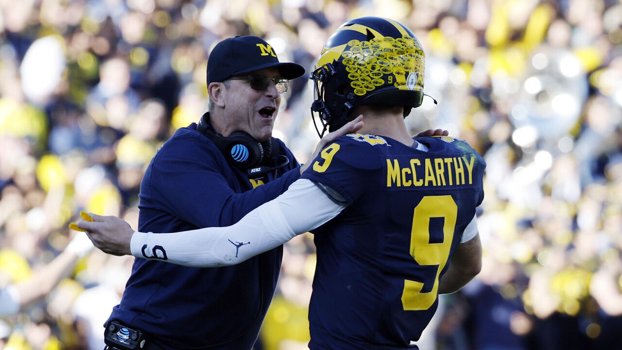 PASADENA, CALIFORNIA - JANUARY 01: Head coach Jim Harbaugh and J.J. McCarthy #9 of the Michigan Wolverines celebrate after scoring a touchdown in the first quarter against the Alabama Crimson Tide during the CFP Semifinal Rose Bowl Game at Rose Bowl Stadium on January 01, 2024 in Pasadena, California.