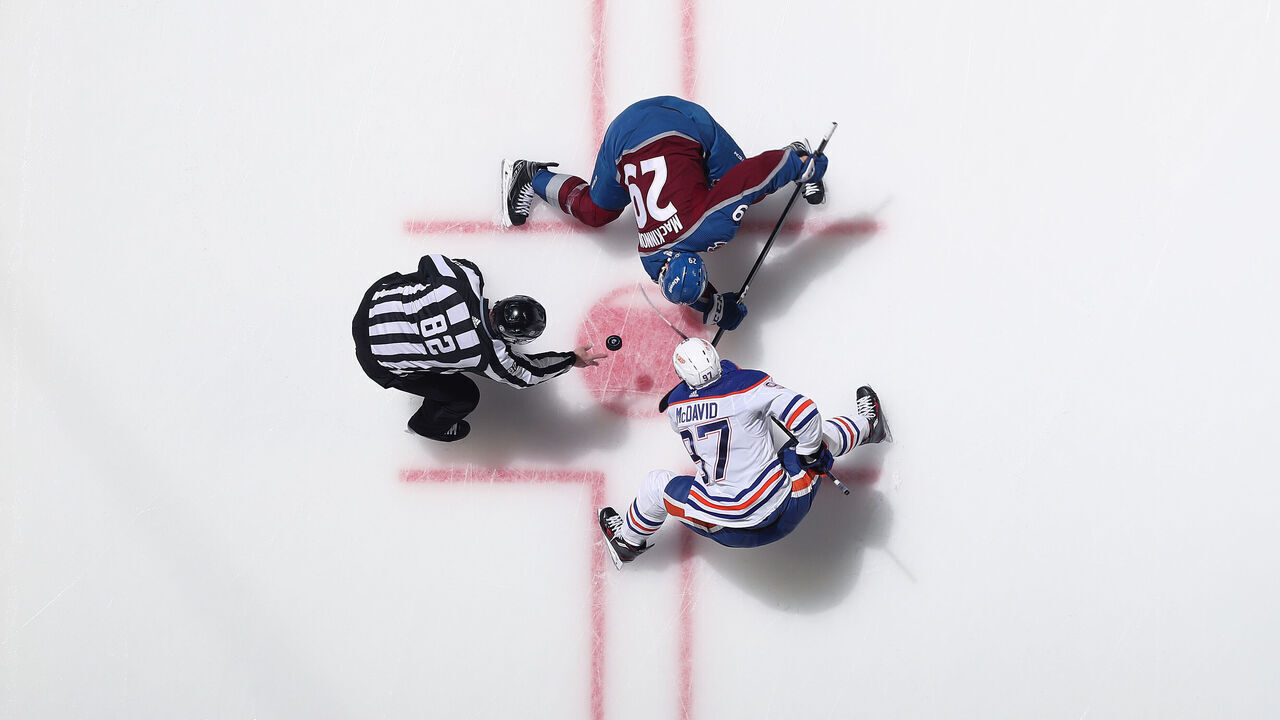 DENVER, COLORADO - APRIL 11: Nathan MacKinnon #29 of the Colorado Avalanche faces off against Connor McDavid #97 of the Edmonton Oilers at Ball Arena on April 11, 2023 in Denver, Colorado.