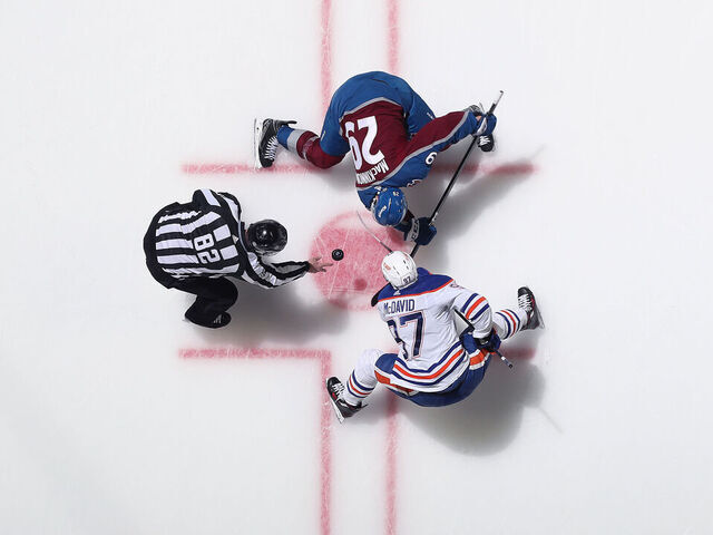 DENVER, COLORADO - APRIL 11: Nathan MacKinnon #29 of the Colorado Avalanche faces off against Connor McDavid #97 of the Edmonton Oilers at Ball Arena on April 11, 2023 in Denver, Colorado.