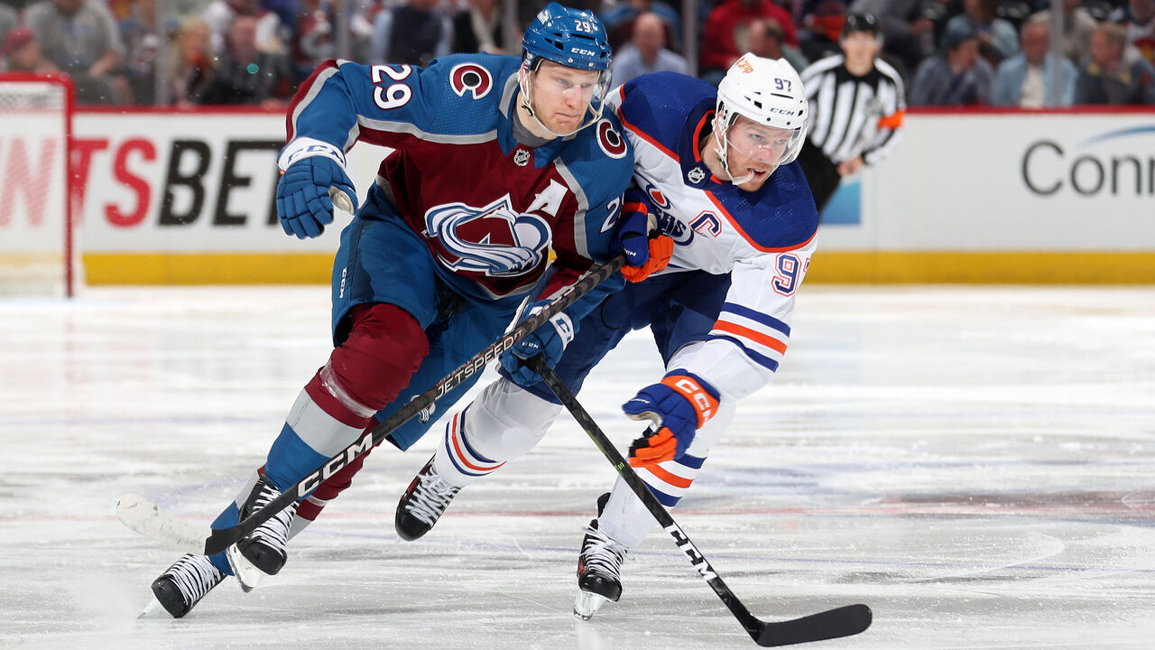 DENVER, COLORADO - APRIL 11: Nathan MacKinnon #29 of the Colorado Avalanche skates against Connor McDavid #97 of the Edmonton Oilers at Ball Arena on April 11, 2023 in Denver, Colorado.