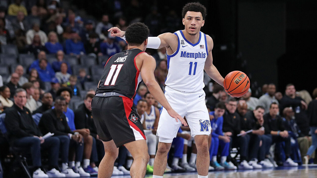 MEMPHIS, TENNESSEE - DECEMBER 30: Jahvon Quinerly #11 of the Memphis Tigers handles the ball against Dezi Jones #11 of the Austin Peay Governors during the first half at FedExForum on December 30, 2023 in Memphis, Tennessee.