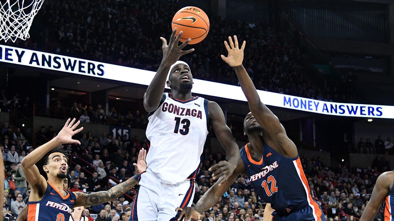 SPOKANE, WA - JANUARY 4: Graham Ike #13 of the Gonzaga Bulldogs catches an entry pass as Houston Mallette and Boubacar Coulibaly #12 of the Pepperdine Waves defend during the first half against the Pepperdine Waves at Spokane Veterans Memorial Arena on January 4, 2024 in Spokane, Washington.