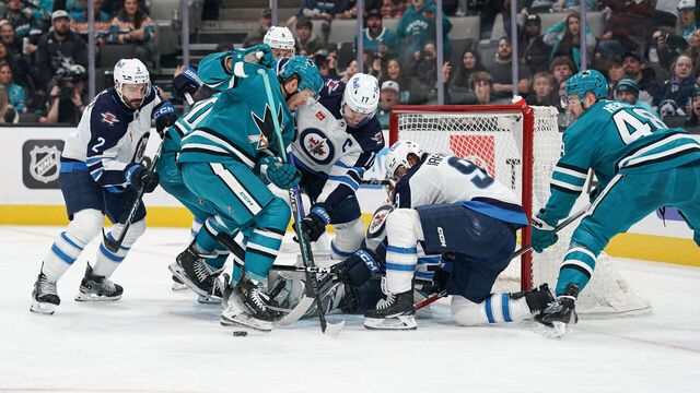 SAN JOSE, CA - JANUARY 4: Mike Hoffman #68 of the San Jose Sharks takes a shot on goal against Connor Hellebuyck #37 of the Winnipeg Jets at SAP Center on January 4, 2024 in San Jose, California.