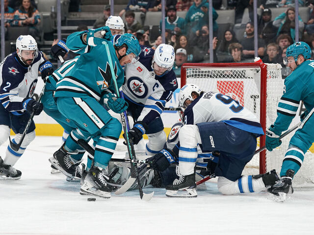 SAN JOSE, CA - JANUARY 4: Mike Hoffman #68 of the San Jose Sharks takes a shot on goal against Connor Hellebuyck #37 of the Winnipeg Jets at SAP Center on January 4, 2024 in San Jose, California.