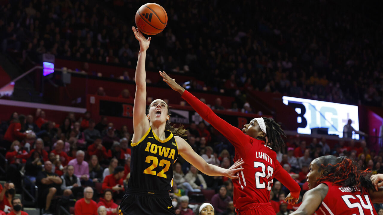 PISCATAWAY, NEW JERSEY - JANUARY 5: Caitlin Clark #22 of the Iowa Hawkeyes attempts a shot as Erica Lafayette #20 and Chyna Cornwell #54 of the Rutgers Scarlet Knights defend during the first half of a game at Jersey Mike's Arena on January 5, 2024 in Piscataway, New Jersey.
