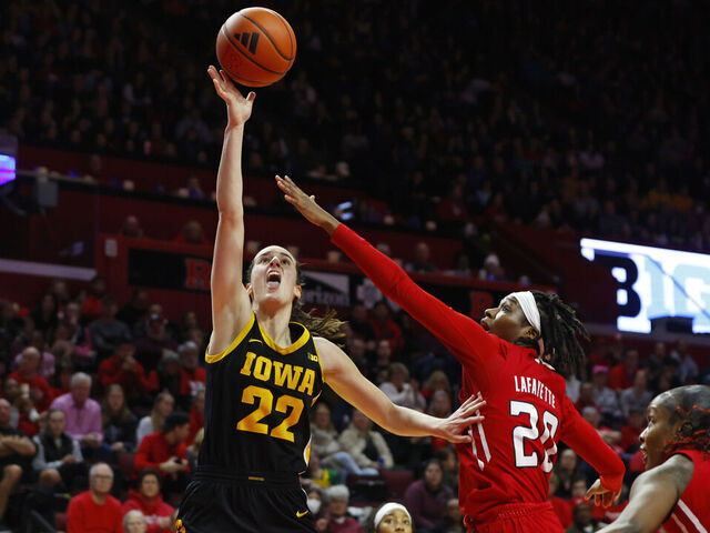 PISCATAWAY, NEW JERSEY - JANUARY 5: Caitlin Clark #22 of the Iowa Hawkeyes attempts a shot as Erica Lafayette #20 and Chyna Cornwell #54 of the Rutgers Scarlet Knights defend during the first half of a game at Jersey Mike's Arena on January 5, 2024 in Piscataway, New Jersey.