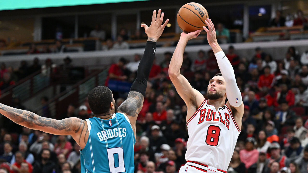 CHICAGO, ILLINOIS - JANUARY 05: Zach Lavine #8 of the Chicago Bulls shoots over Miles Bridges #0 of the Charlotte Hornets in the first half on January 05, 2024 at United Center in Chicago, Illinois.