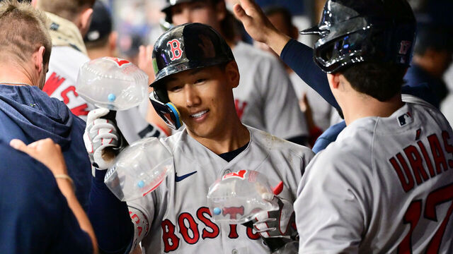 ST PETERSBURG, FLORIDA - SEPTEMBER 04: Masataka Yoshida #7 of the Boston Red Sox celebrates with teammates in the dugout after hitting a two-run home run in the eighth inning against the Tampa Bay Rays at Tropicana Field on September 04, 2023 in St Petersburg, Florida.