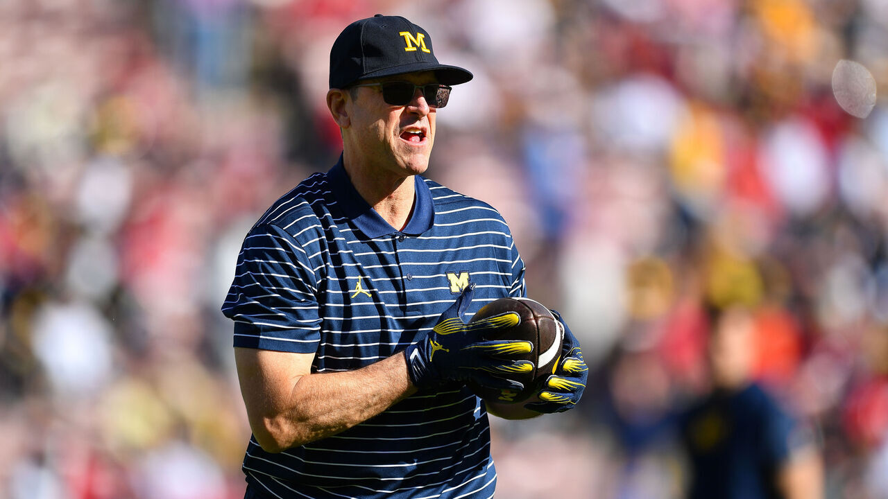 PASADENA, CA - JANUARY 01: Head Coach Jim Harbaugh of the Michigan Wolverines catches a pass before the Alabama Crimson Tide game versus the Michigan Wolverines CFP Semifinal at the Rose Bowl Game on January, 1, 2024, at the Rose Bowl Stadium in Pasadena, CA.