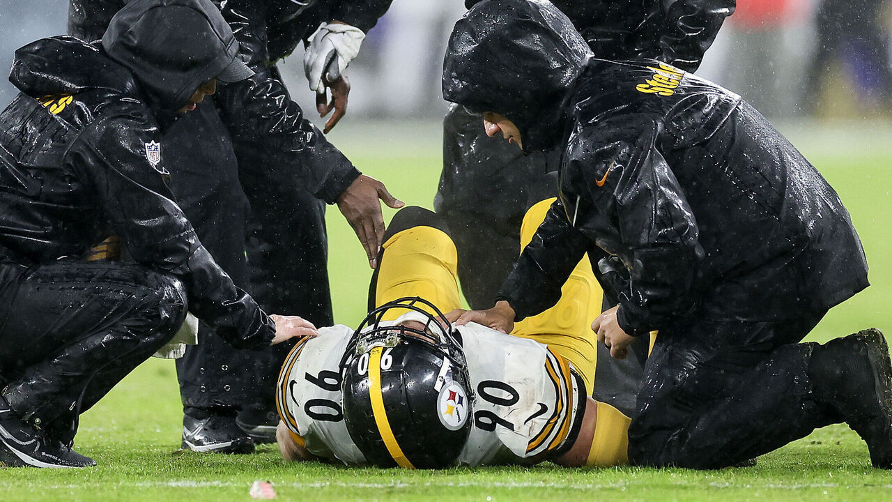 BALTIMORE, MARYLAND - JANUARY 06: T.J. Watt #90 of the Pittsburgh Steelers is looked at by medical staff after an injury during the second half of a game against the Baltimore Ravens at M&T Bank Stadium on January 06, 2024 in Baltimore, Maryland.