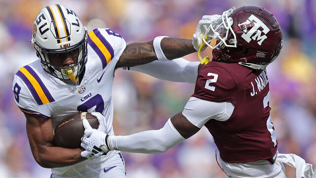 BATON ROUGE, LOUISIANA - NOVEMBER 25: Malik Nabers #8 of the LSU Tigers runs with the ball as Jacoby Mathews #2 of the Texas A&M Aggies defends during the first half at Tiger Stadium on November 25, 2023 in Baton Rouge, Louisiana.
