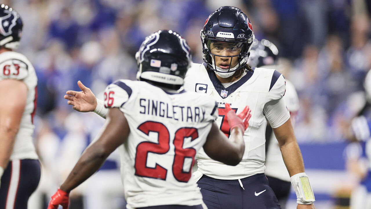 INDIANAPOLIS, INDIANA - JANUARY 06: C.J. Stroud #7 and Devin Singletary #26 of the Houston Texans celebrate a touchdown during the fourth quarter against the Indianapolis Colts at Lucas Oil Stadium on January 06, 2024 in Indianapolis, Indiana.
