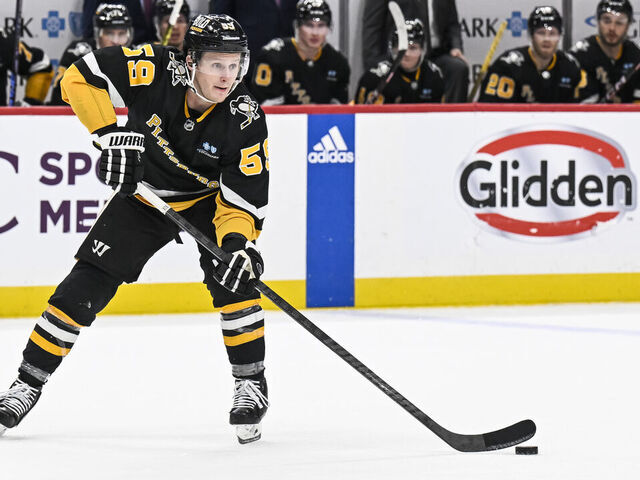 PITTSBURGH, PA - DECEMBER 21: Pittsburgh Penguins left wing Jake Guentzel (59) passes the puck during the overtime period in the NHL game between the Pittsburgh Penguins and the Carolina Hurricanes on December 21, 2023, at PPG Paints Arena in Pittsburgh, PA.