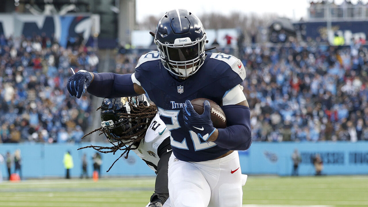 NASHVILLE, TENNESSEE - JANUARY 07: Derrick Henry #22 of the Tennessee Titans runs with the ball for a touchdown during the second quarter against the Jacksonville Jaguars at Nissan Stadium on January 07, 2024 in Nashville, Tennessee.