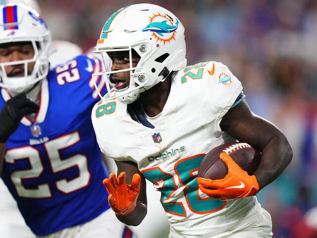 MIAMI GARDENS, FLORIDA - JANUARY 07: De'Von Achane #28 of the Miami Dolphins rushes during the first quarter against the Buffalo Bills at Hard Rock Stadium on January 07, 2024 in Miami Gardens, Florida.