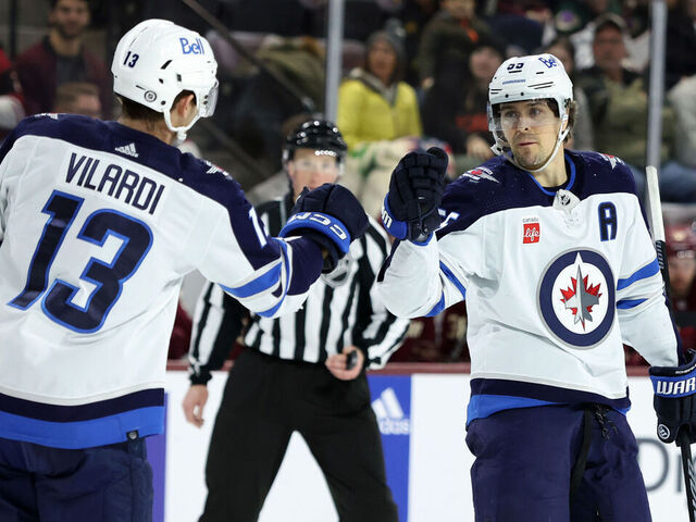 TEMPE, ARIZONA - JANUARY 07: Mark Scheifele #55 of the Winnipeg Jets celebrates with teammate Gabriel Vilardi #13 after scoring an empty net goal against the Arizona Coyotes during the third period at Mullett Arena on January 07, 2024 in Tempe, Arizona.